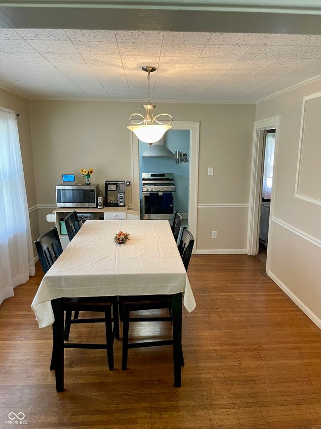 dining space featuring wood finished floors | Image 7
