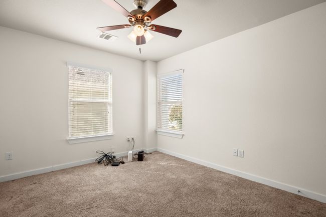 The guest bedrooms offer ample space and natural light, providing a comfortable retreat for visitors. | Image 17