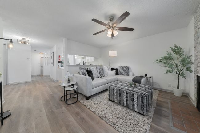 Living area featuring wood finished floors, baseboards, and ceiling fan | Image 8