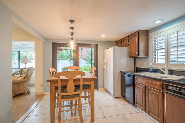 kitchen with wood cabinets | Image 14