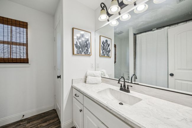Full bath with vanity and wood finished floors | Image 18