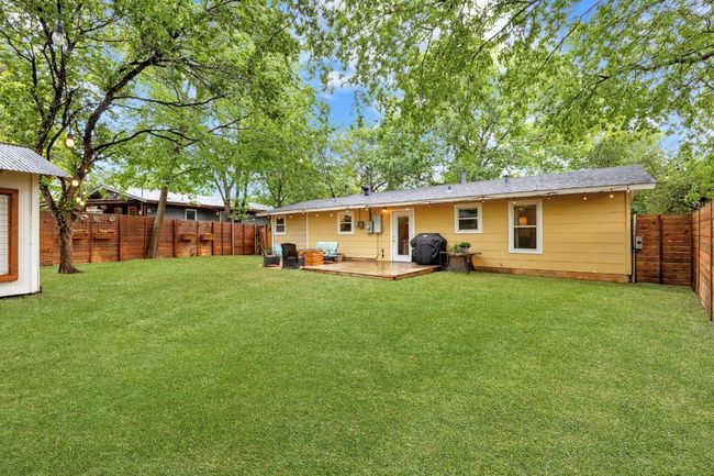 Rear view of house with a fenced backyard | Image 21
