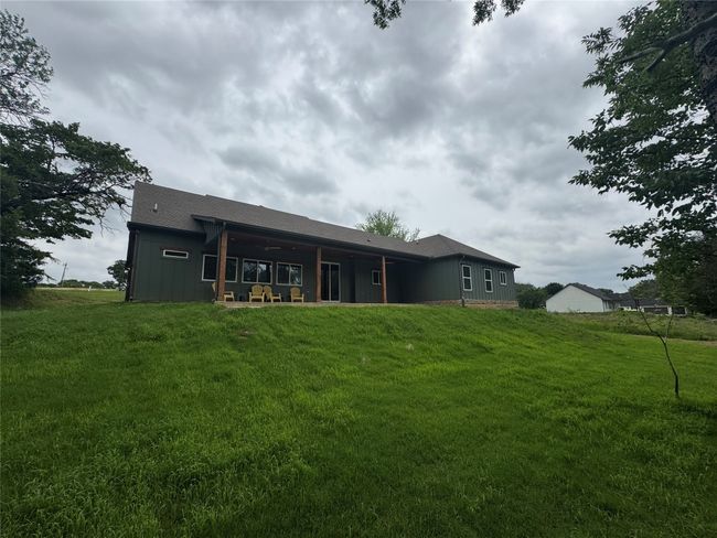 Back of house featuring a yard and a patio | Image 36
