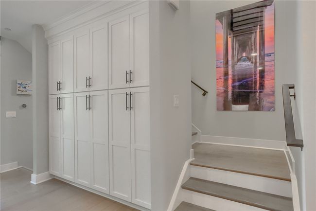 Beautiful custom built in pantry cabinets. Hardwood staircases leading to second floor. | Image 18