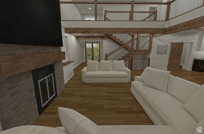 Optional living room with stairs, wood finished floors, a towering ceiling, and a fireplace | Image 6