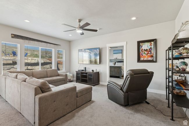Living room with carpet flooring, ceiling fan, and recessed lighting | Image 19
