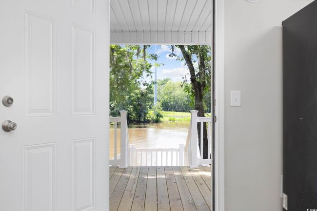 Doorway featuring a water view and wood finished floors | Image 26