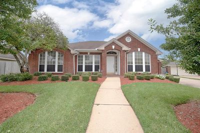 A closer look of the home showing the gorgeous landscaping surrounding the front of the property. Home provides amazing elevation too. | Image 3