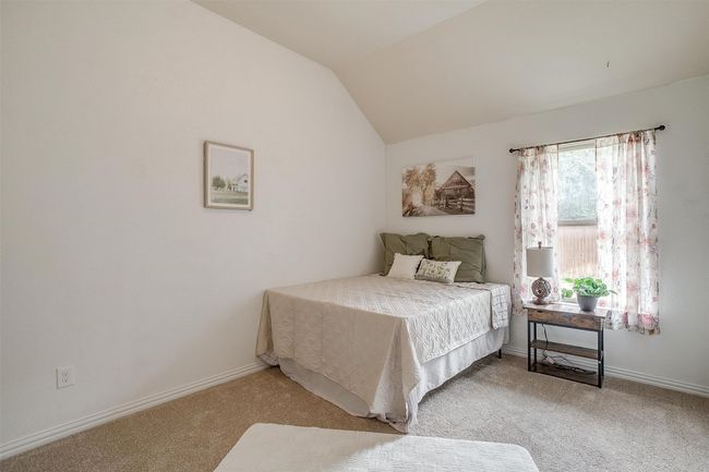Bedroom featuring carpet floors and lofted ceiling | Image 29