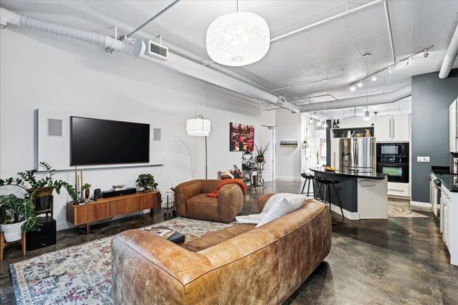 Living area featuring concrete floors and track lighting | Image 8