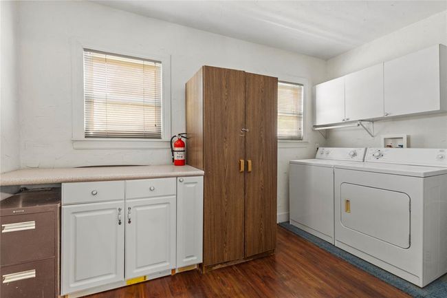 Laundry room featuring dark hardwood / wood-style floors, washing machine and dryer, and cabinets | Image 22