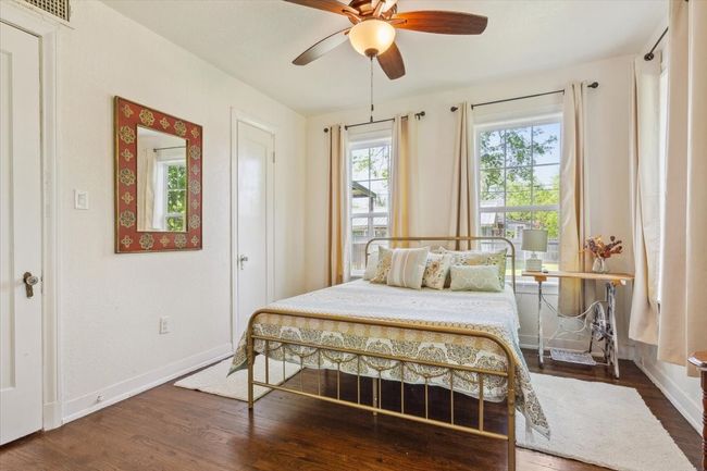 Bedroom with wood finished floors, baseboards, and a ceiling fan | Image 24