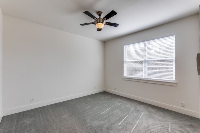 Empty room featuring ceiling fan, carpet flooring, and baseboards | Image 24