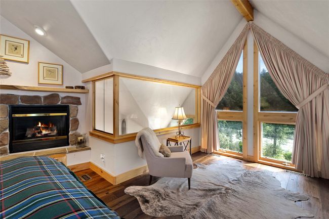 Primary bedroom with a view, fireplace and plenty of natural light | Image 22