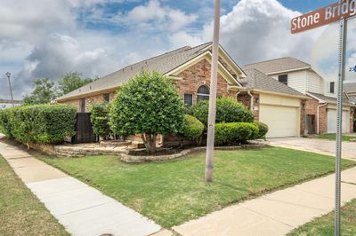 View of front of home featuring a front yard and a garage | Image 2