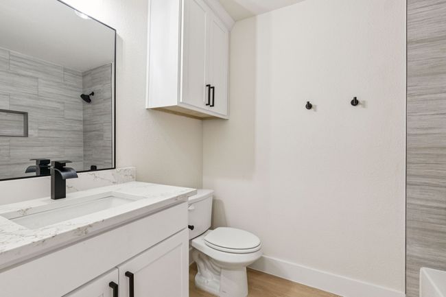 Full bath featuring vanity, wood finished floors, and a shower | Image 13
