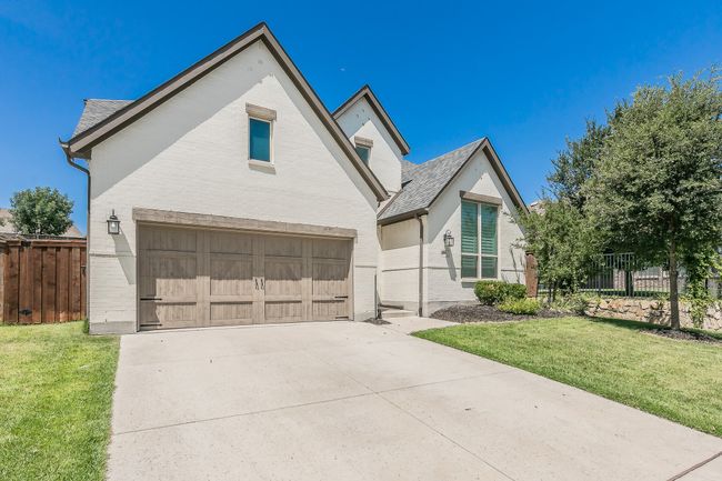 View of front of home featuring a garage, driveway, and brick siding | Image 27