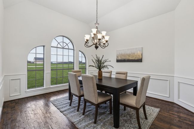 Dining area featuring lofted ceiling and wainscoting | Image 5