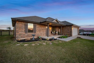 View of front of home featuring a garage and a yard | Image 2