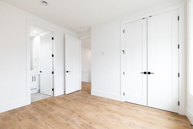 Unfurnished bedroom with light wood-style flooring, a closet, and ensuite bath | Image 37
