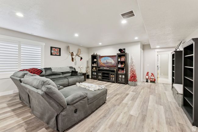 Living room featuring baseboards, visible vents, and light wood-style flooring | Image 35