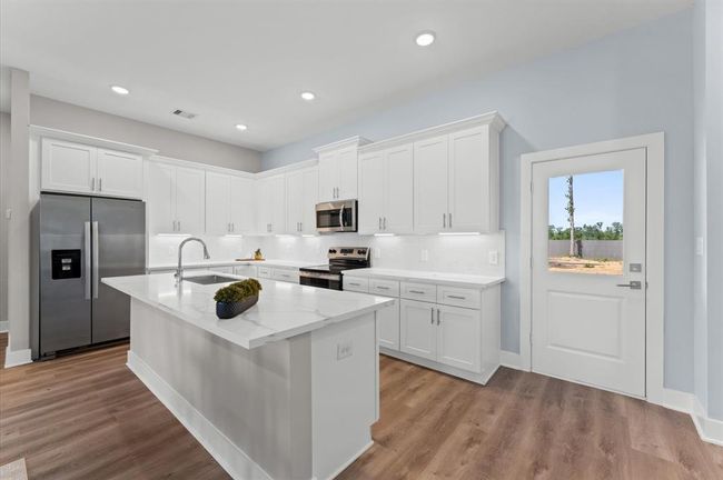 Stunning kitchen with quartz countertops, ample cabinetry, and stainless steel appliances included. | Image 14