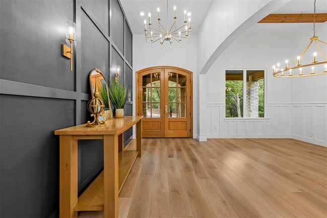Foyer featuring high vaulted ceiling, light wood-type flooring, french doors, an inviting chandelier, and beam ceiling | Image 3