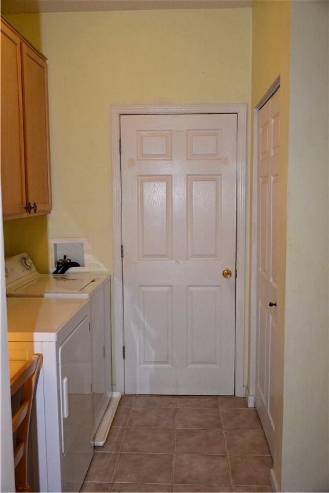 Utility room straight ahead, and pantry opposite the washer/dryer | Image 24