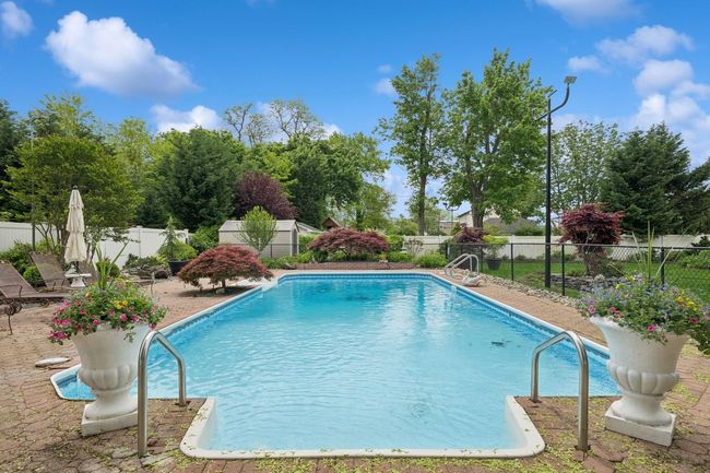 View of pool with a fenced backyard and a patio area | Image 24