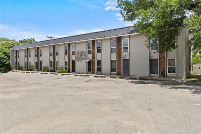 View of building exterior featuring uncovered parking | Image 23