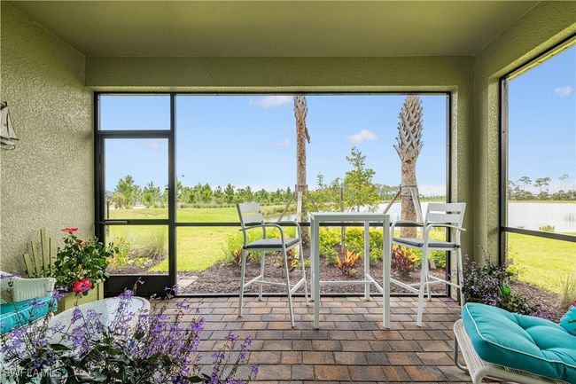 Sunroom featuring a water view | Image 24