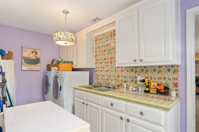 Full size laundry room with deep freeze, sink and hanging rod | Image 25