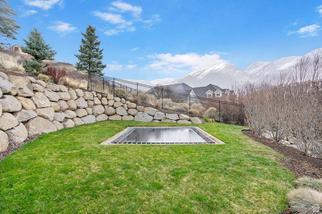 View of yard with a mountain view and fence | Image 95