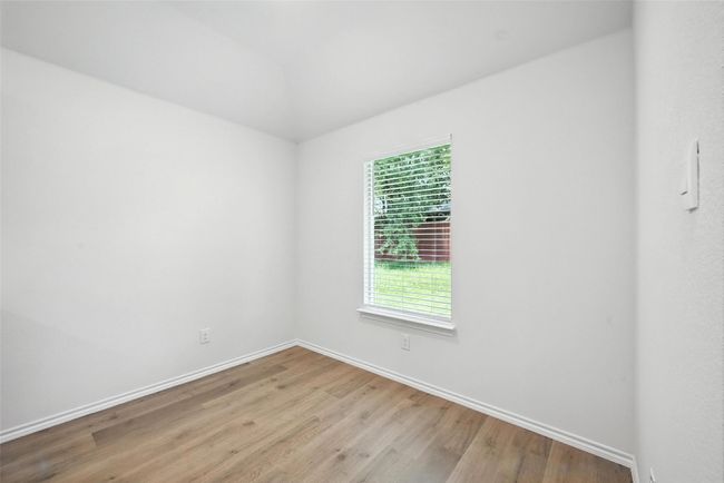 Unfurnished room featuring light wood finished floors and vaulted ceiling | Image 11