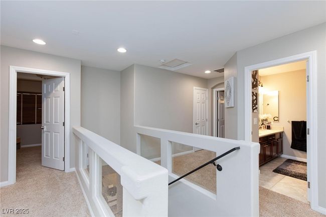 Hall featuring baseboards, visible vents, recessed lighting, and light colored carpet | Image 18