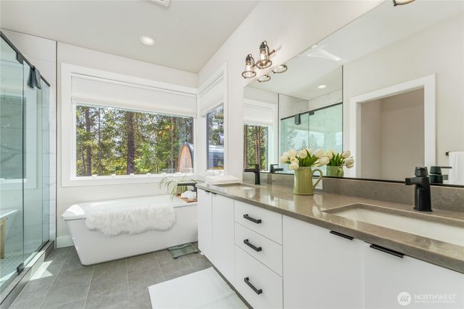 Indulge in the expansive primary bathroom, where luxury meets tranquility | Image 19