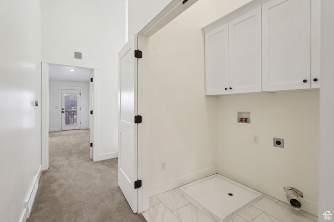 Washroom with visible vents, hookup for an electric dryer, baseboards, cabinet space, and washer hookup | Image 35