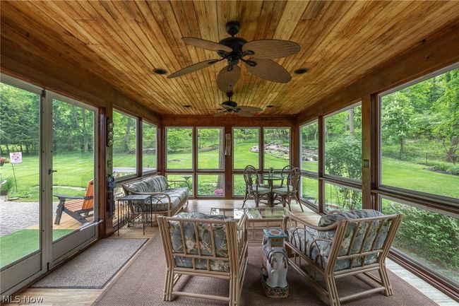 Sunroom / solarium featuring wood ceiling, plenty of natural light, and ceiling fan | Image 30