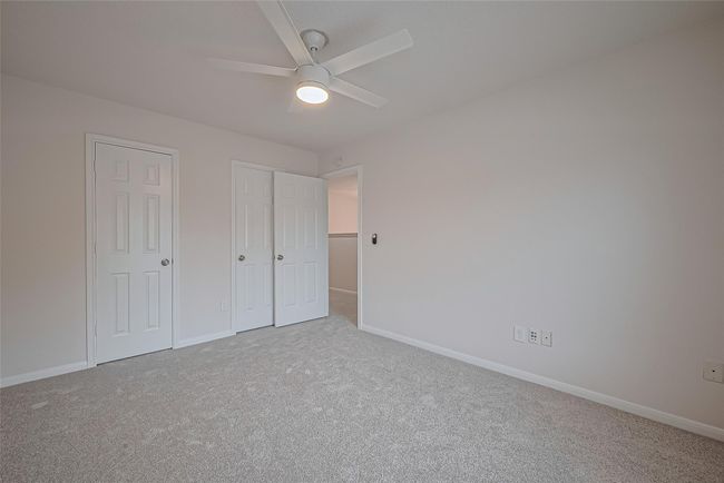 One of three secondary bedrooms upstairs, featuring closet space, all new carpet, freshly painted walls and ceiling, and a brand new ceiling fan for added comfort. | Image 28