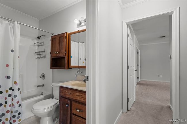 Full bath featuring toilet, ornamental molding, vanity, and shower / tub combo with curtain | Image 26