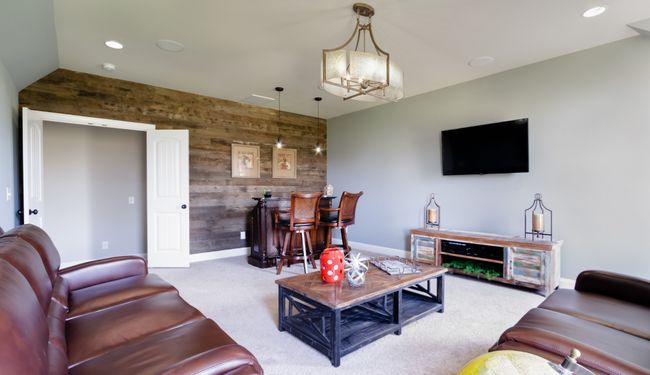The bonus room features a barnwood accent wall. | Image 52