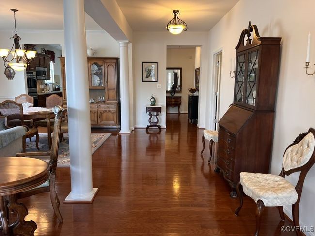 Entryway with a chandelier, decorative columns, and dark hardwood / wood-style floors | Image 6