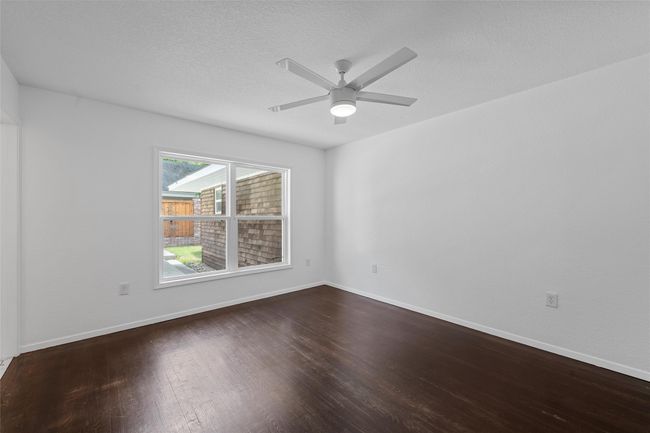 Empty room featuring wood finished floors, ceiling fan, and baseboards | Image 20