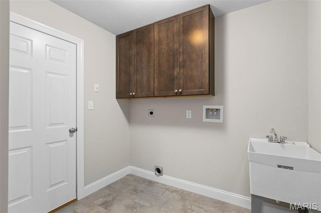 Laundry room with cabinet space, baseboards, washer hookup, and electric dryer hookup | Image 21