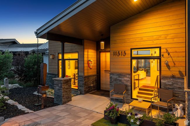 Doorway to property featuring stone siding and covered porch | Image 99