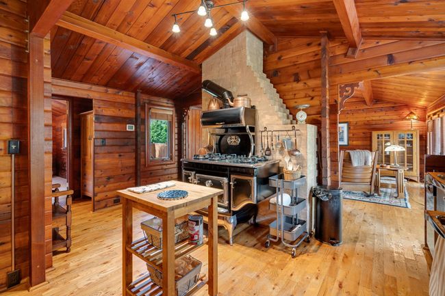 Kitchen with wood walls, hardwood / wood-style floors, and wood ceiling | Image 15
