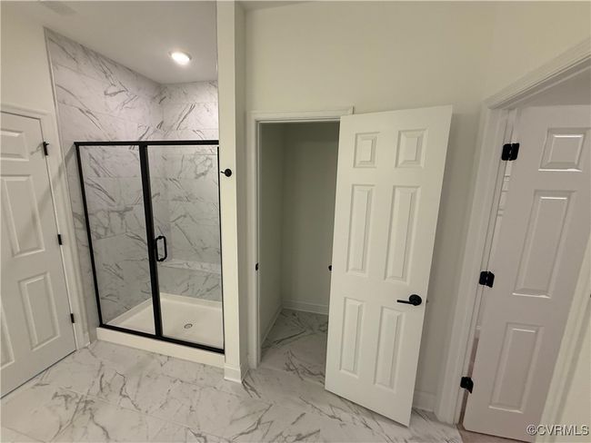 Full bathroom featuring marble look tile flooring, a marble finish shower, baseboards, and recessed lighting | Image 11