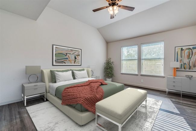 Bedroom featuring wood finished floors, vaulted ceiling, and a ceiling fan | Image 13