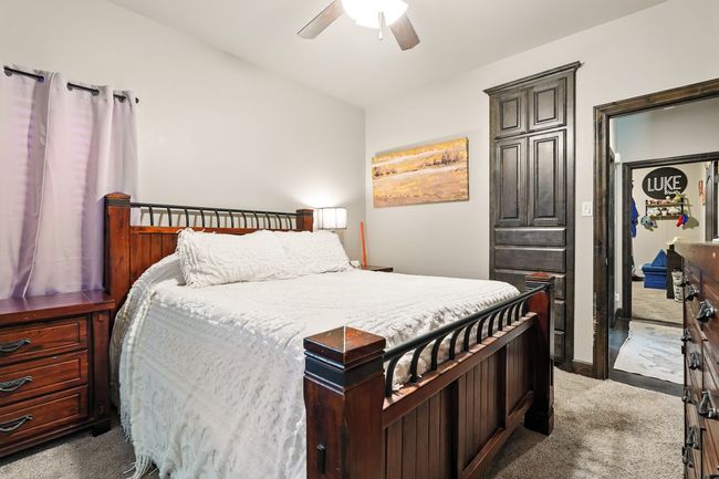Bedroom with carpet and a ceiling fan | Image 21