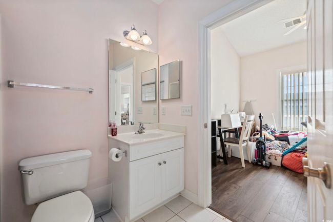 Bathroom featuring vanity, toilet, and wood finished floors | Image 14